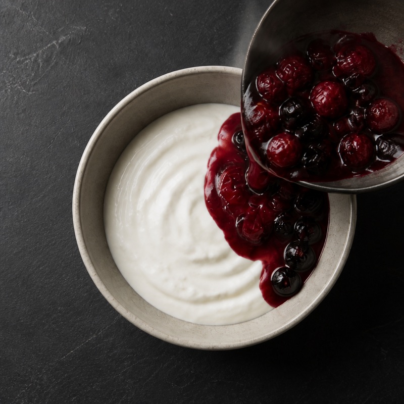 Step 2: Put the yogurt in a bowl and pour the warm berries over.