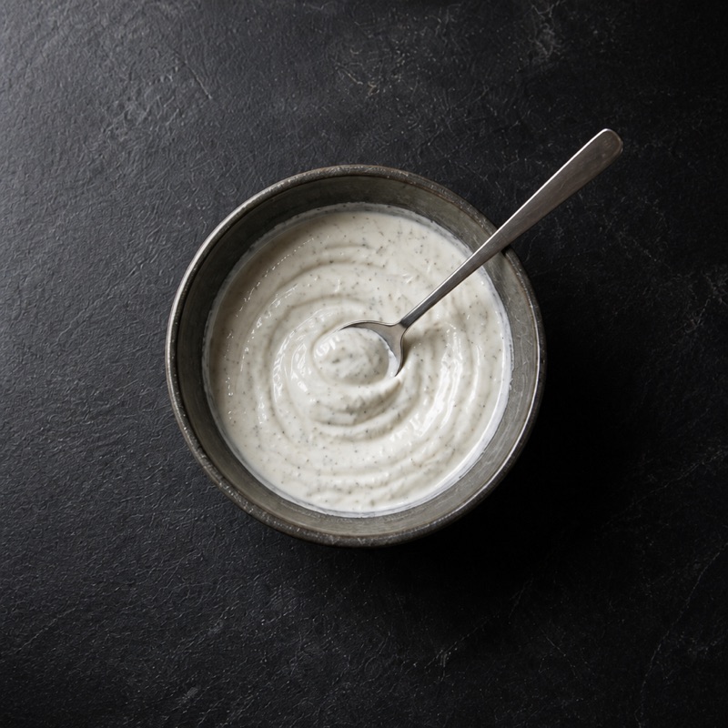 Step 2: Mix yogurt with crushed garlic and salt for the sauce.
