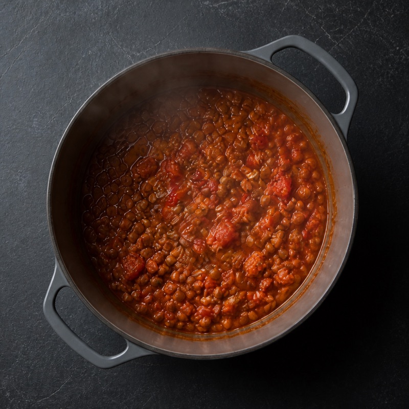 Step 2: Add lentils and tomatoes, simmer 5 minutes.